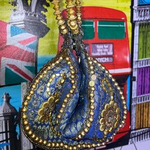 Beautiful Cato Purse in Blue and Gold with a Stylish Circle Handle.